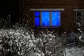 Window of a residential building with a garland. Brick house at night. Feeling of a holiday