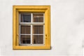 Window of a restored half-timbered house partly plastered with sandstone framing, decorated with yellow colour