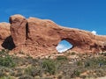 Window Rock at Arches National Park, with hikers walking toward it Royalty Free Stock Photo