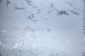 Window in the room covered with frosty mosaic in winter. Frost patterns on glass