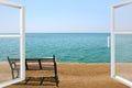 Window of room overlooking empty bench near coastline at tropical resort. Exotic relaxation Royalty Free Stock Photo