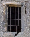 An old window with a metal grille of a historical building .Background or texture Royalty Free Stock Photo