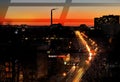 Night city light traffic at orange sunset building and traffic urban panorama Tallinn Estonia