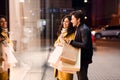 Window shopping. Young couple looking at showcase Royalty Free Stock Photo