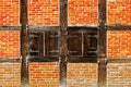 Window with shutters in brick wall of half timbered house Royalty Free Stock Photo