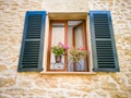 A window with shutters in a Mediterranean style Royalty Free Stock Photo