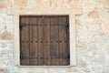 Window shutters on old stone wall. Building facade wall with wooden shutters closed. Architecture structure and design Royalty Free Stock Photo