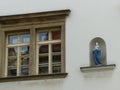 Window with a niche with a statue of the Virgin Mary to Prague in Czech Republic.