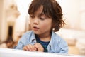 Window, sitting and boy in home for rain, bored or lonely for disappointed or sad for season outdoor. Young child or kid Royalty Free Stock Photo