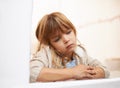 Window, sitting and child in house for bored, lonely or disappointed for rain or weather outdoor. Young girl or kid and Royalty Free Stock Photo