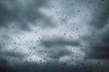 Window with small raindrops on the surface of a glass against a blue cloudy sky after a storm. Weather forecast. Rainy Royalty Free Stock Photo