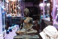 In the window is a small Buddha statue partially covered in gold Royalty Free Stock Photo