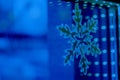 Window with snowflake and bokeh lights line. Horizontal with copy space. Hotel and restaurant booking on holidays, party, winter