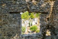 Window in the stone wall overlooking the ghost town Kayakoy. Mugla - Turkey