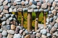 Window in the stone wall, wooden grating