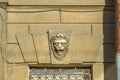 Window with stucco molding with lion head ornament above