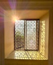 A window with a sun shining through it Royalty Free Stock Photo