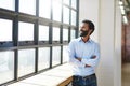 Window, thinking and a business man arms crossed in the office with a smile or vision of future success. Happy, idea and Royalty Free Stock Photo