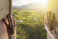 Window to the new life, hands open window with gorgeous landscape nature view on summer