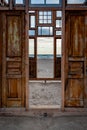 Window to the sea. View at sea during sunset through an open abandon window and door. Royalty Free Stock Photo