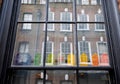 Window of traditional Huguenot weaver`s house on Princelet Street, Spitalfields, showing reflection and quirky model houses