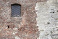 Window on truncated brick wall of old fortress