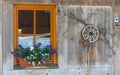 Window of typical austrian farmhouse decorated with geranium flowers Royalty Free Stock Photo