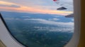 Window View on Airplane, Wing of Airplane With Sunlight on Sky, Cloudy Background, Royalty Free Stock Photo