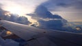 Window View on Airplane, Wing of Airplane With Sunlight on Sky, Cloudy Background, Royalty Free Stock Photo