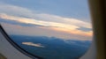 Window View on Airplane, Wing of Airplane With Sunlight on Sky, Cloudy Background, Royalty Free Stock Photo