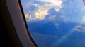 Window View on Airplane, Wing of Airplane With Sunlight on Sky, Cloudy Background, Royalty Free Stock Photo