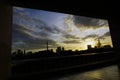 Window with view of the city in the sunset time. Royalty Free Stock Photo