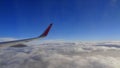 Window view of a clouded sky outside a flying aircraft Royalty Free Stock Photo