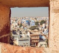 Window view with colorful concrete constructions of city in India