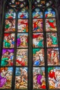 Window view with colorful glass depicting biblical scenes at magnificent Cathedral of Milano, Milan, Italy