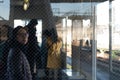 Window view, Lonely woman waiting the train in waiting room on the platform at the railway train station in countryside