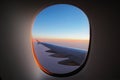 A window view of the wing at dawn