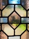 Window with vintage stained glass. Multi-colored pieces of transparent glass. A beautiful window through which light Royalty Free Stock Photo