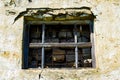 Window in the wall of an abandoned house. Old house. The ruins of the house. Window with bars Royalty Free Stock Photo