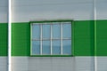 a window in the wall of a modern factory or a large shopping center. Details of the aluminum facade of an industrial building. The Royalty Free Stock Photo