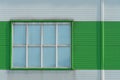 a window in the wall of a modern factory or a large shopping center. Details of the aluminum facade of an industrial building. The Royalty Free Stock Photo