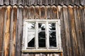 Window and wall of the old abandoned wooden house. Royalty Free Stock Photo