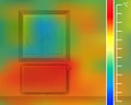 Window on the wall in the room. Steel panel radiator for a thermal imager. Colored thermographic image of the scan camera. Royalty Free Stock Photo