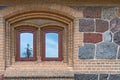 Window in the wall of rubble masonry. The sky and the tree are reflected in the glass Royalty Free Stock Photo