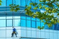 Window washer cleaning facade of modern office building Royalty Free Stock Photo