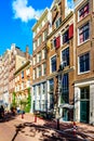 A window washer on a tall ladder cleaning the windows of historic houses Singelgracht in the historic center of Amsterdam Royalty Free Stock Photo