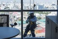 Window washers cleaning the glass facade of a modern building, high risk work. Royalty Free Stock Photo