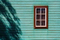 Window on weatherboard cabin wall.