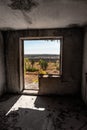 Window from weathered abandoned room to sunny day Royalty Free Stock Photo