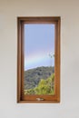 Window in white room with rainbow and wooden frame Royalty Free Stock Photo